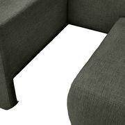 Nahaufnahme einer Recamiere in dunkelgrünem Stoff, Perspektive von oben.