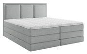 Graues Boxspringbett mit gestepptem Topper, seitliche Perspektive