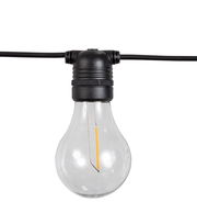 Nahaufnahme einer klaren Glühbirne an einer schwarzen Lichterkette, frontal betrachtet.