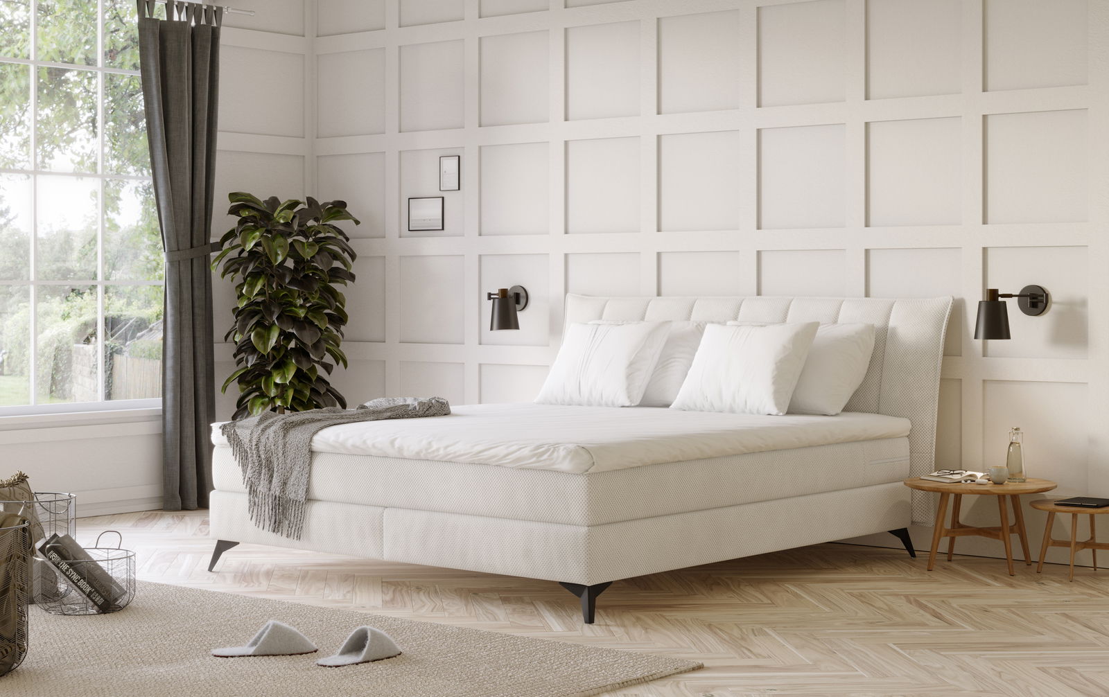 Elegantes Boxspringbett in einem stilvollen Schlafzimmer, seitliche Perspektive mit weißen Kissen und einer grauen Decke, umgeben von moderner Dekoration.