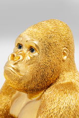 Goldene Gorilla-Dekofigur in Nahaufnahme, die den Kopf leicht zur Seite neigt.