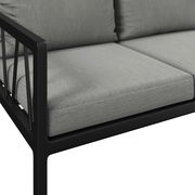 Nahaufnahme einer modernen Gartenbank mit grauen Kissen und schwarzem Metallrahmen, seitliche Perspektive.