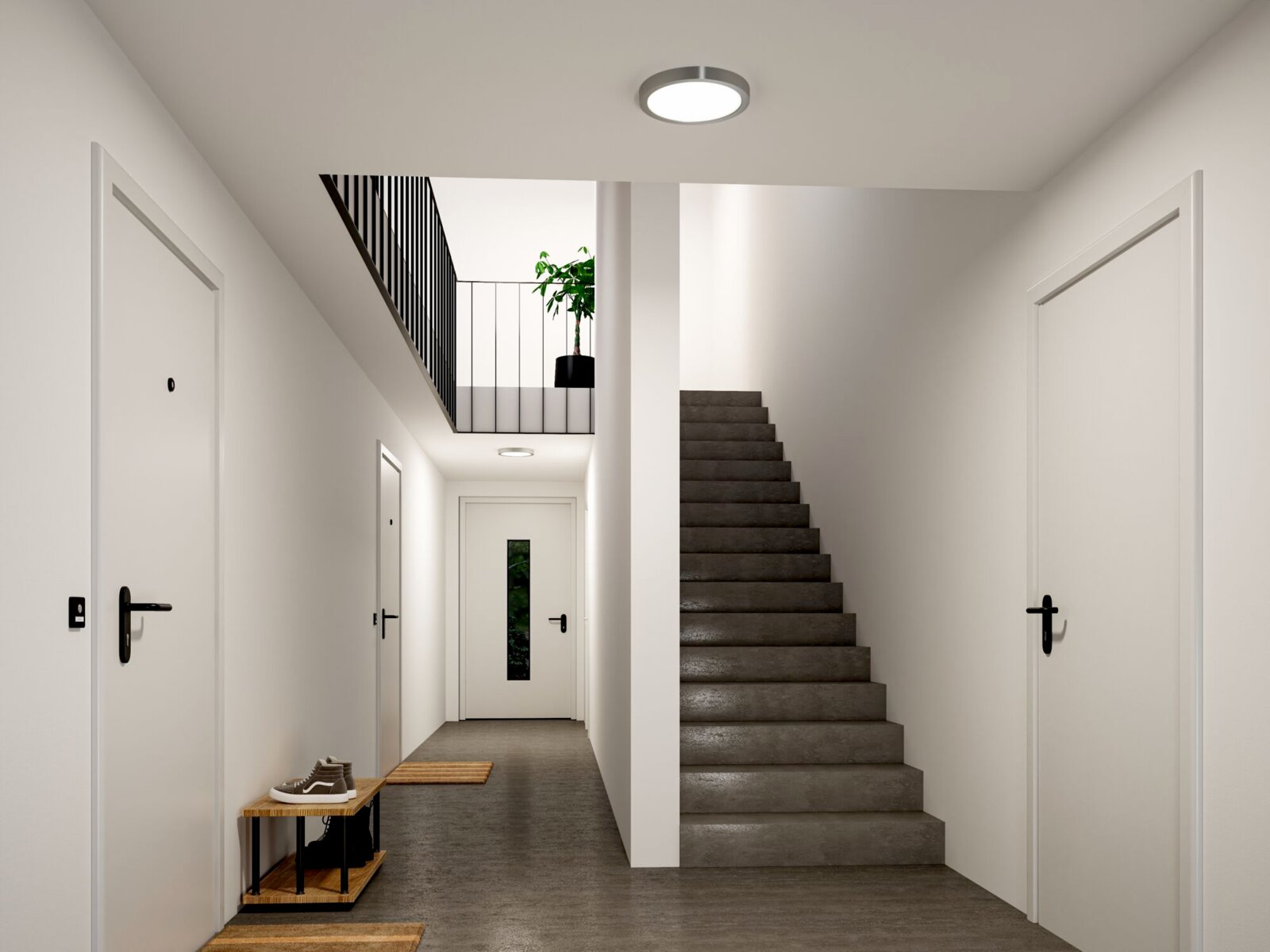 Moderner Hausflur mit grauer Treppe, weißen Türen und runder Deckenleuchte, frontal aus Augenhöhe aufgenommen.