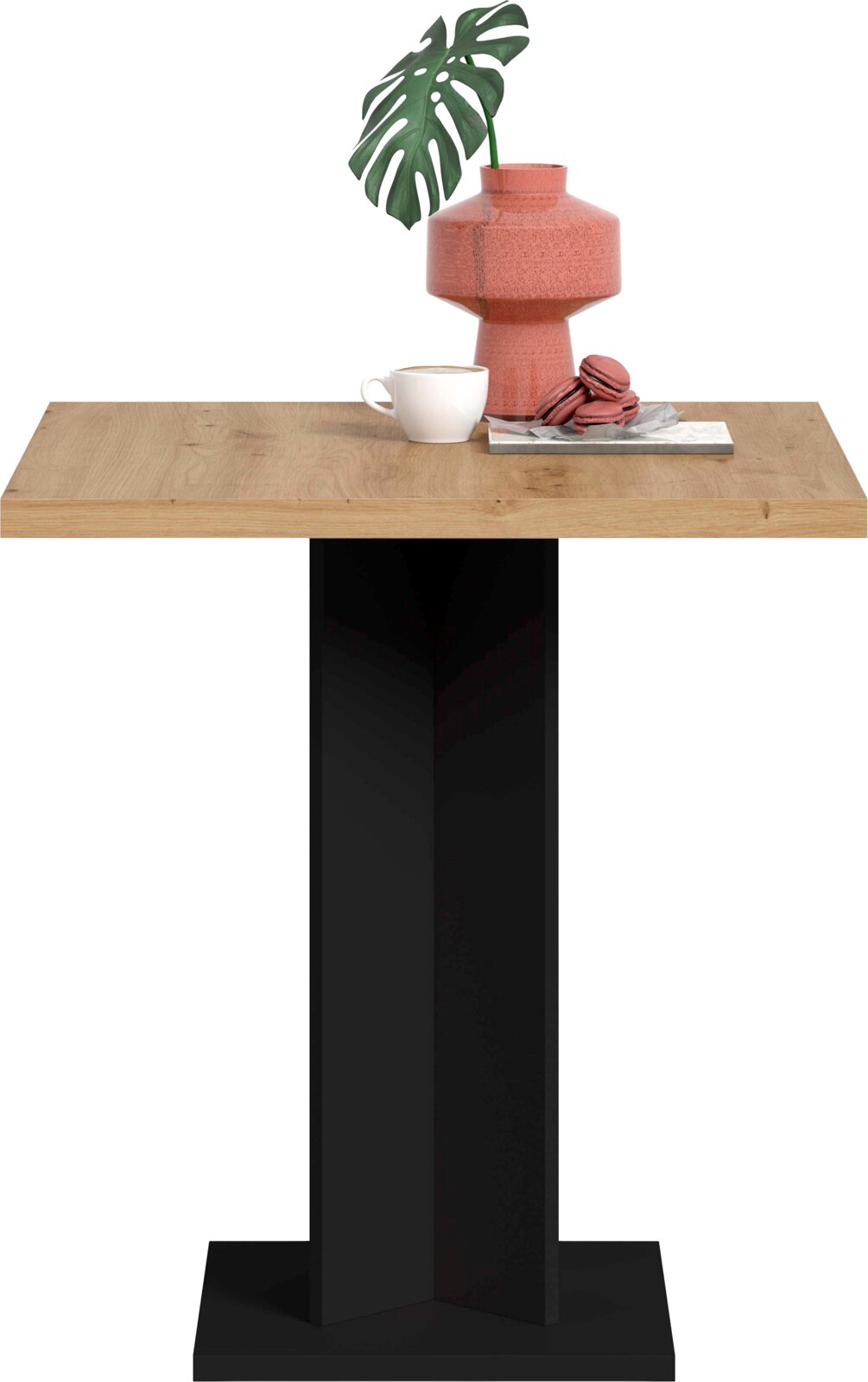 Rechteckiger Tisch mit heller Holzplatte und schwarzem Mittelfuß auf breiter Bodenplatte, frontal aus leicht erhöhter Perspektive; auf der Platte rosa Vase mit Blatt, weiße Tasse und Makronen auf Tablett