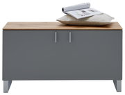 Garderobenbank mit grauer Front und Holzoberfläche, darauf ein Kissen und eine Zeitschrift, frontal betrachtet.