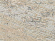 Nahaufnahme eines Designer-Teppichs mit abstraktem Muster in Beige- und Grautönen, von oben betrachtet.