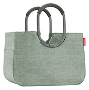 Grüne Einkaufstasche mit stabilen Griffen, seitliche Perspektive