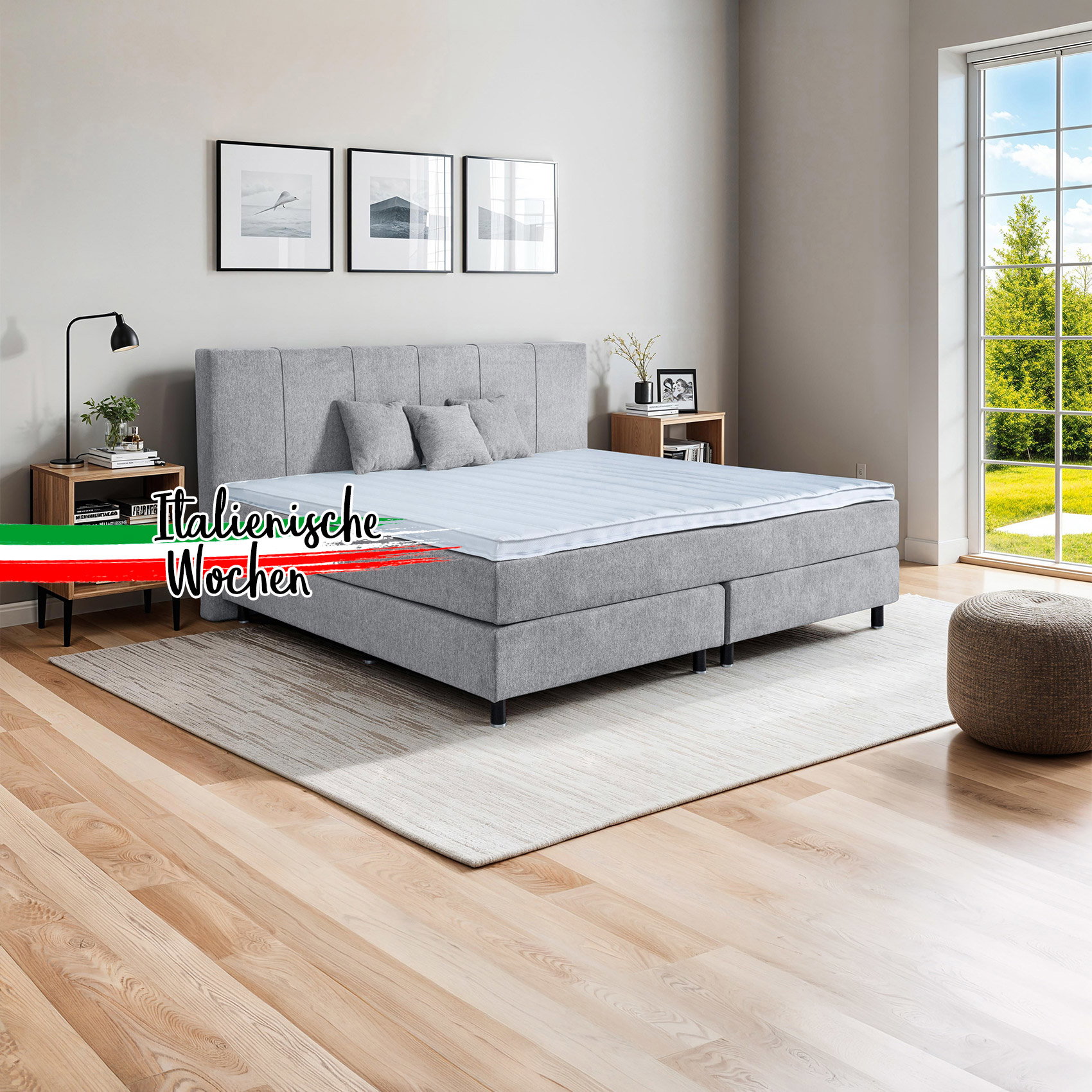 Modernes Boxspringbett in Grau mit Polsterkopfteil im hellen Schlafzimmer mit Fenster und Nachttischen