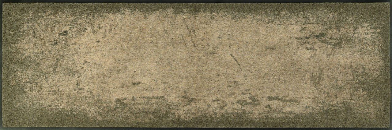 Fußmatte in verschiedenen Brauntönen mit einer texturierten Oberfläche, von oben betrachtet.