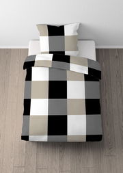 Bettwäsche-Set mit großem Karomuster in Schwarz, Weiß, Grau und Beige, aus der Vogelperspektive auf einem Bett fotografiert.