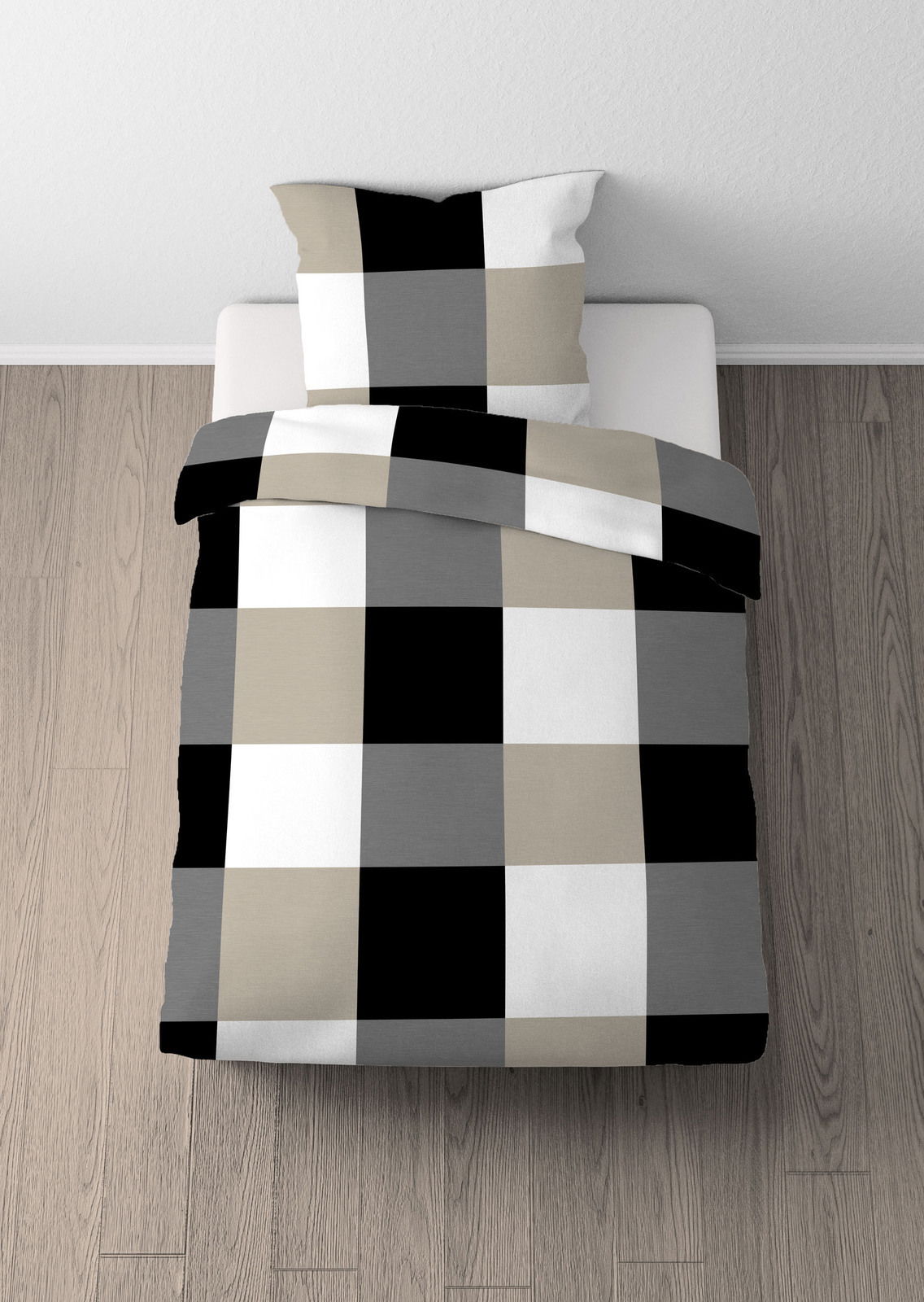 Bettwäsche-Set mit großem Karomuster in Schwarz, Weiß, Grau und Beige, aus der Vogelperspektive auf einem Bett fotografiert.
