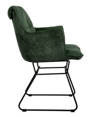 Seitenansicht eines grünen Armlehnstuhls mit schwarzem Metallgestell