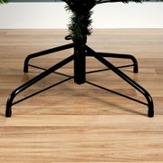 Metalen standaard van een kerstboom op een houten vloer, zijaanzicht