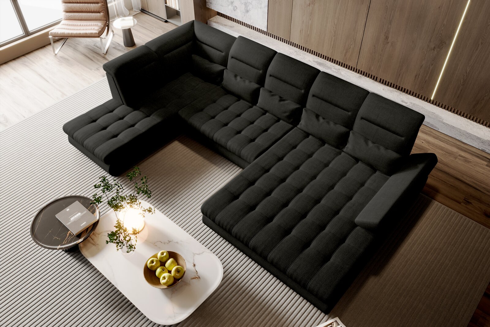 Schwarzes, modernes U-förmiges Ecksofa mit gesteppten Sitzflächen und verstellbaren Rückenlehnen in einem Wohnzimmer neben einem Couchtisch Ansicht aus der Vogelperspektive von schräg oben.