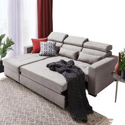 Gemütliche Rundecke in hellem Grau mit verstellbaren Kopfstützen, dekoriert mit Kissen und einer dunklen Decke, aus der Perspektive von vorne links betrachtet.