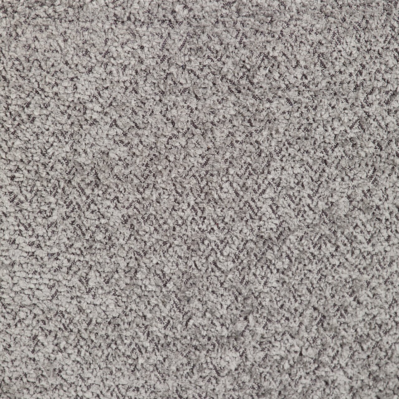 Nahaufnahme einer grauen, strukturierten Teppichoberfläche.