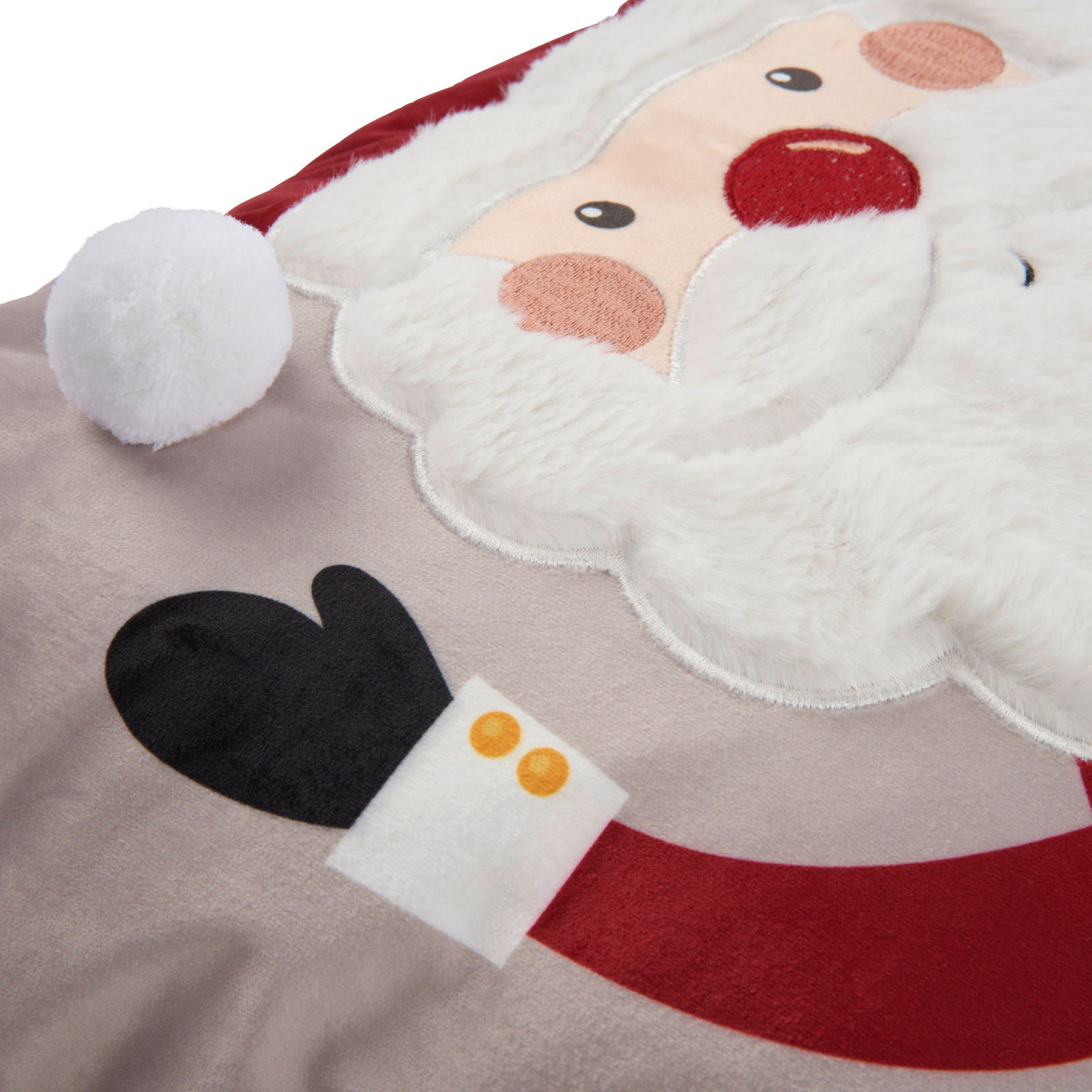 Nahaufnahme einer Kissenhülle mit Weihnachtsmann-Motiv, das Gesicht und Bart des Weihnachtsmanns zeigt, mit einem weißen Bommel an der Mütze.