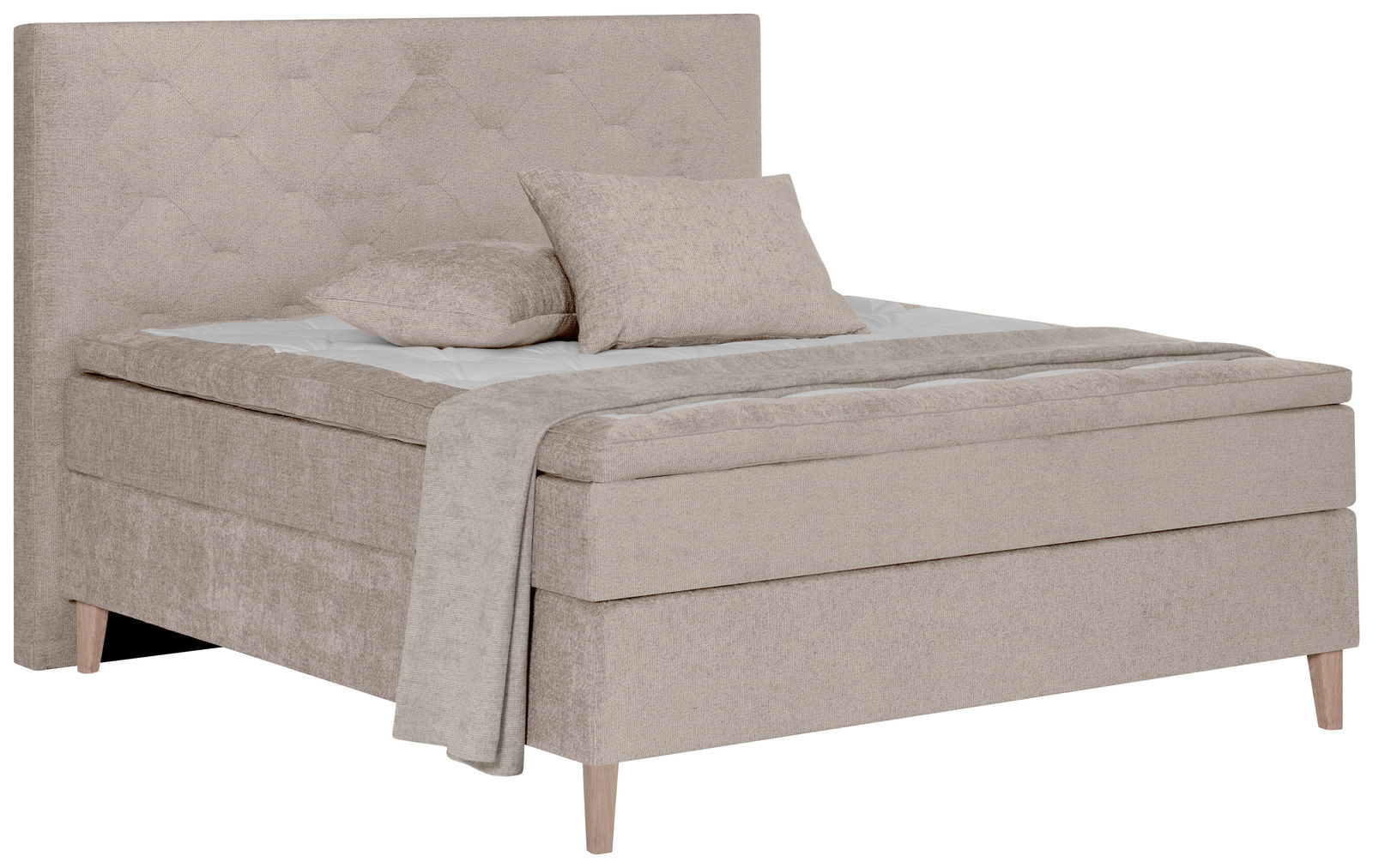 Beiges Boxspringbett mit hohem, gestepptem Kopfteil und zwei Kissen, seitliche Perspektive