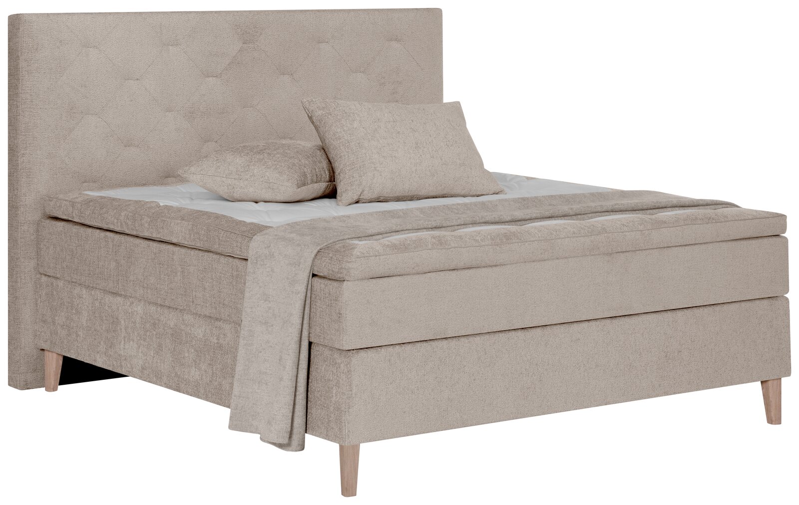 Beiges Boxspringbett mit hohem, gestepptem Kopfteil und zwei Kissen, seitliche Perspektive