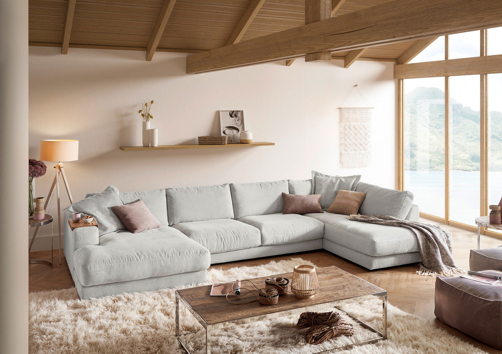 Gemütliche Rundecke in einem modernen Wohnzimmer mit Holzdecke und großen Fenstern, seitliche Perspektive.