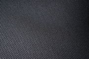 Nahaufnahme eines schwarzen, strukturierten Stoffes, vermutlich Sitzfläche eines Drehstuhls.