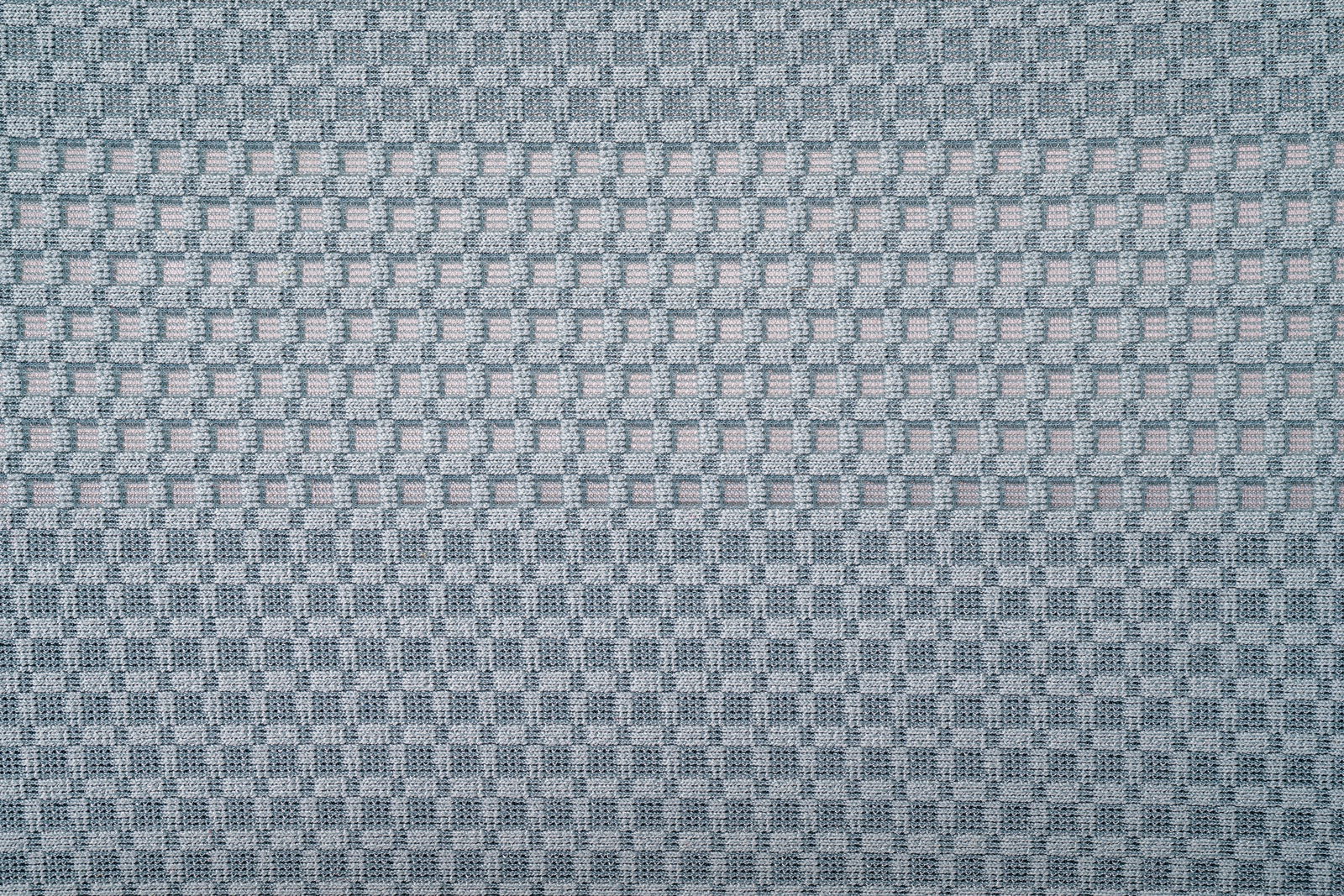 Nahaufnahme eines grauen Stoffmusters mit quadratischem Gitterdesign, Draufsicht