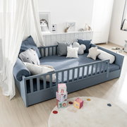 Kinderbett in Blau mit Rausfallschutz, dekoriert mit Kissen und Spielzeug, seitliche Perspektive