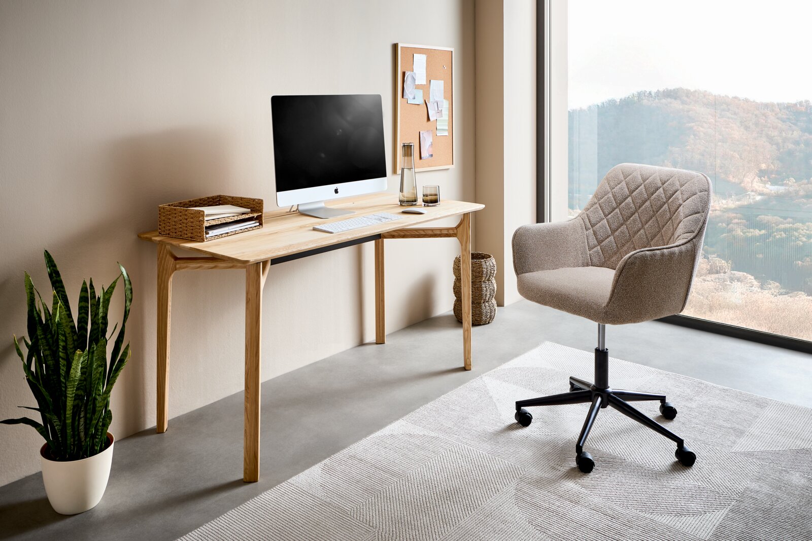 Modern houten bureau met computer, mand en planten, zijaanzicht.