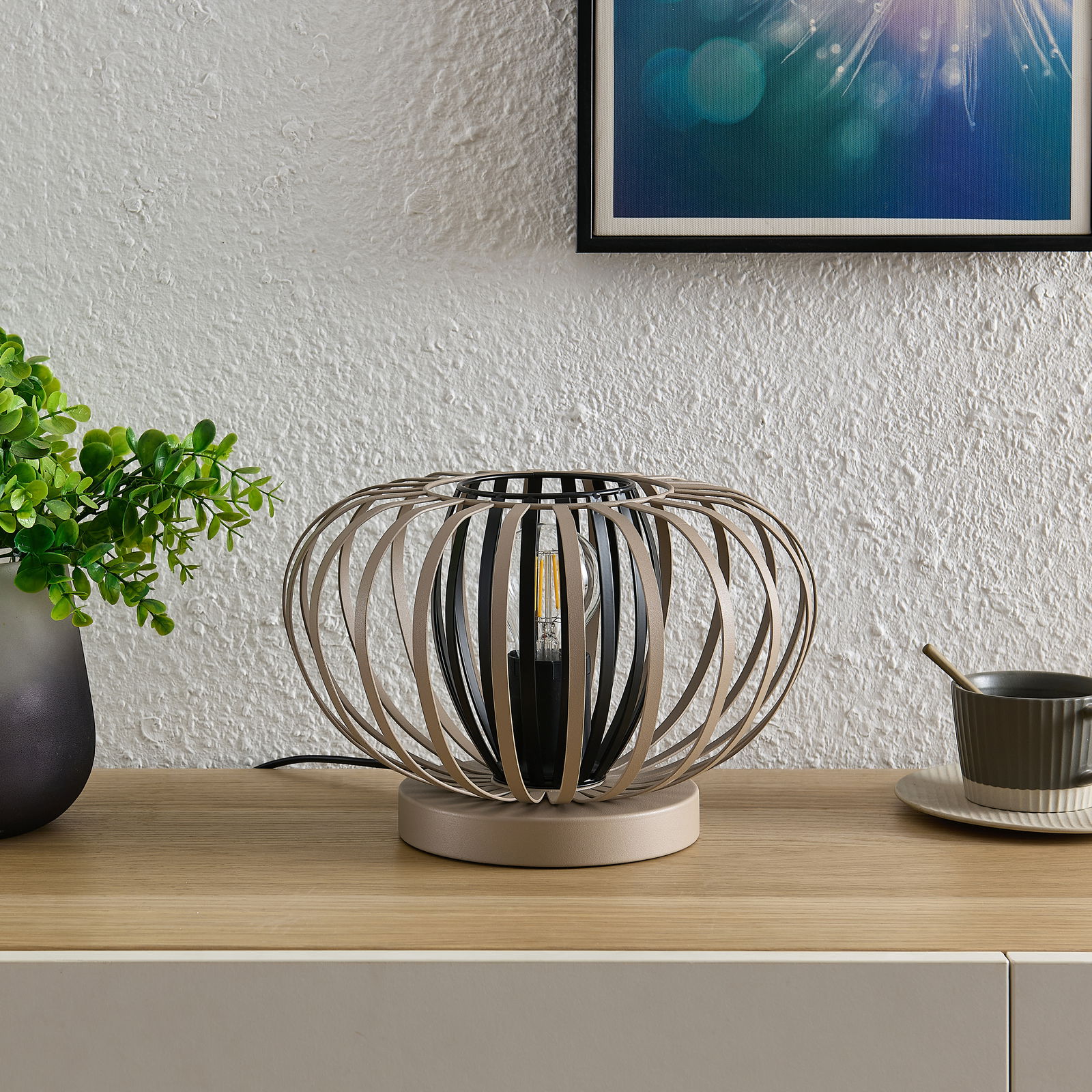 Moderne Tischleuchte mit kugelförmigem, offenen Design aus Metallstreben, seitliche Perspektive.