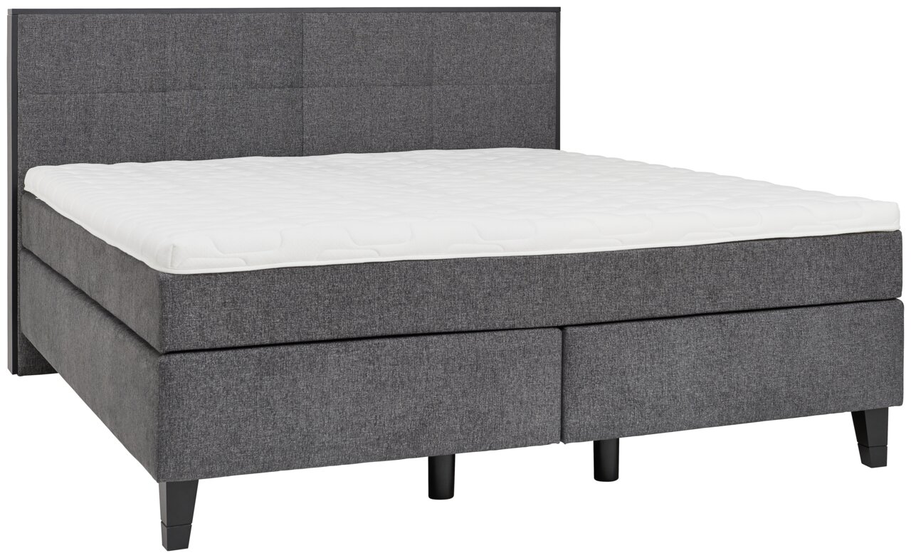 Graues Boxspringbett mit gepolstertem Kopfteil, seitliche Perspektive