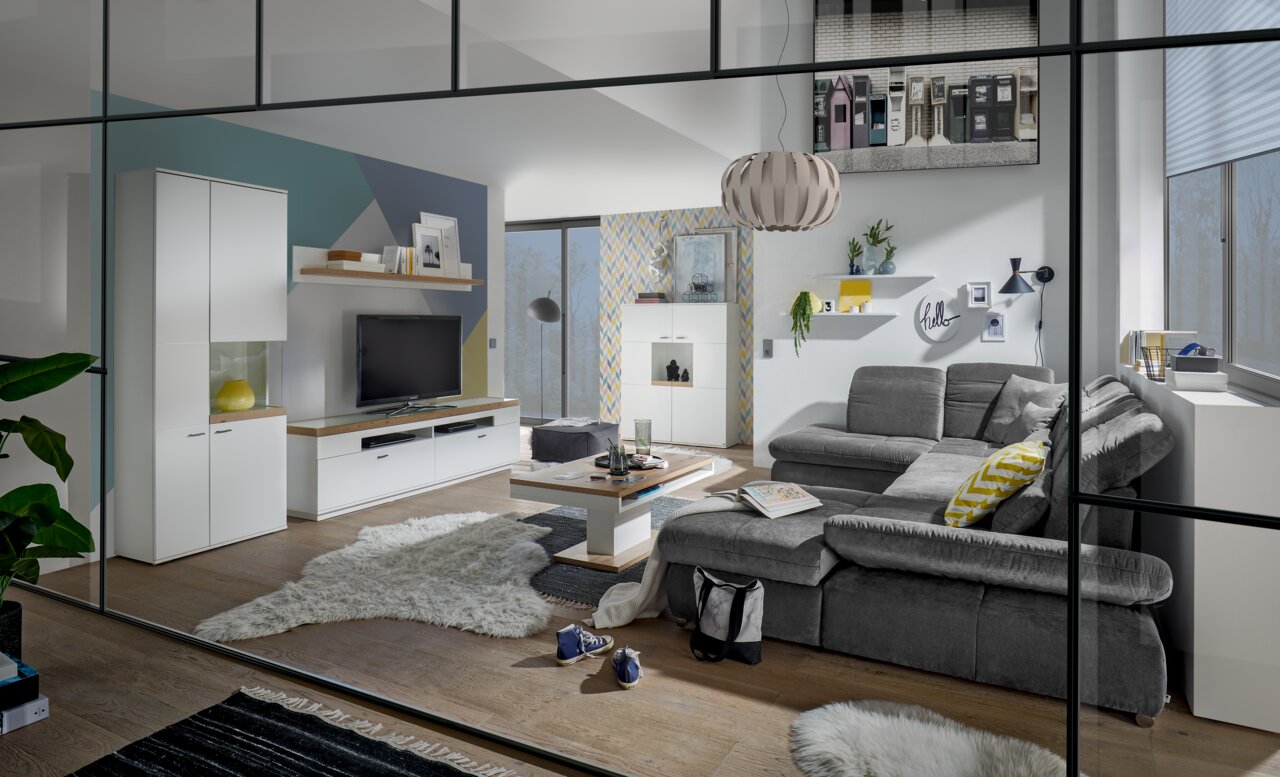 Modernes Wohnzimmer mit grauem Sofa, Couchtisch und TV-Lowboard in einer stilvollen Einrichtung. Perspektive: Frontalansicht.