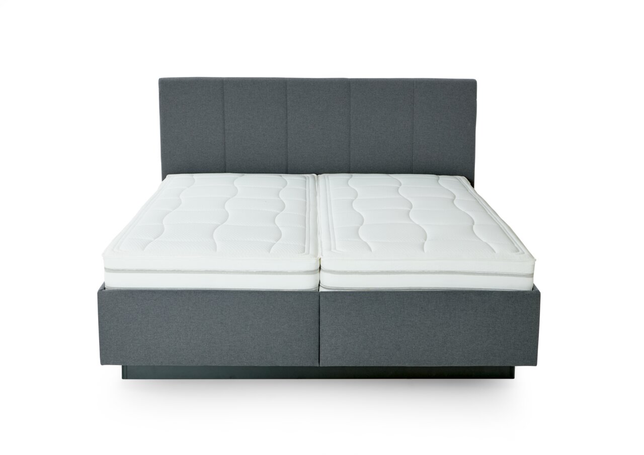 Frontale Ansicht eines grauen Polsterbetts mit zwei weißen Matratzen.