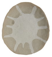 Rundes Ornament mit unregelmäßigem, weißem Muster auf beiger Oberfläche, Draufsicht