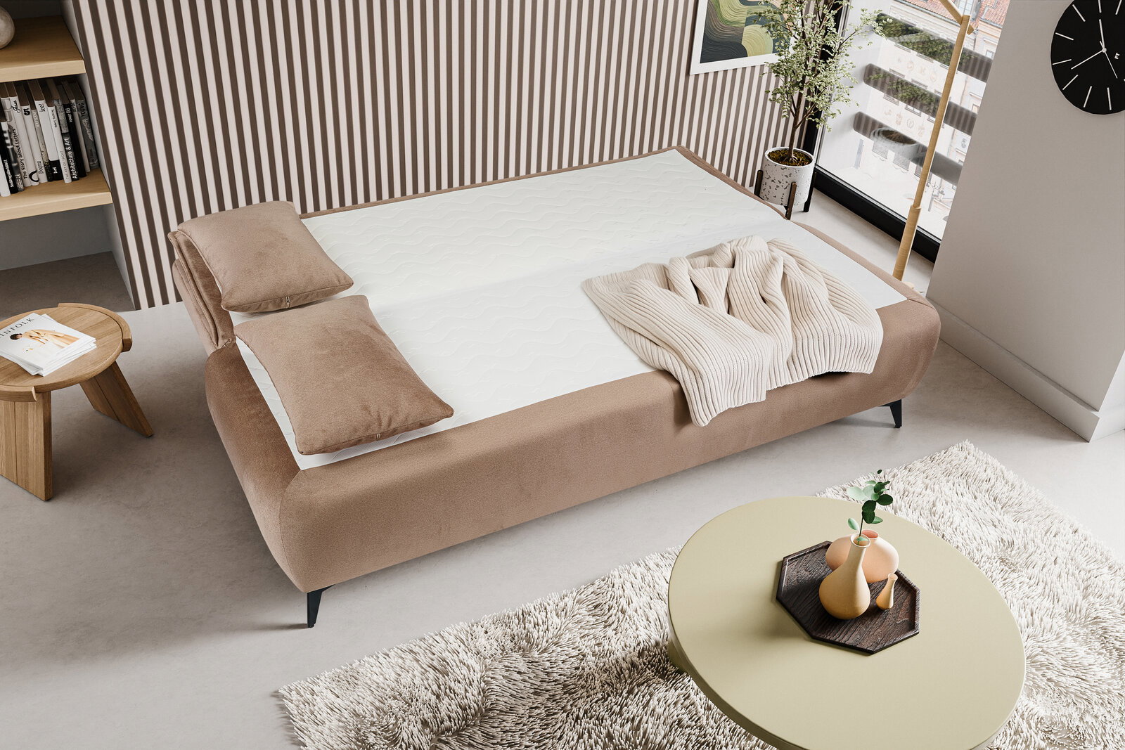 Modernes Polsterbett in Beige mit weißer Matratze, zwei Kissen und gestrickter Decke im hellen Schlafzimmer; Perspektive: schräg von oben (Vogelperspektive) von der Fußseite