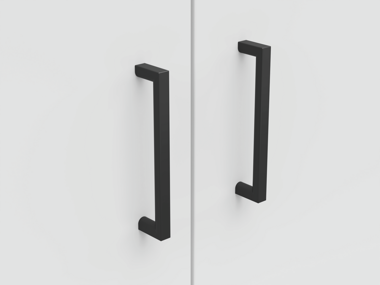 Carryhome Kommode MULTISTAURAUM Nahaufnahme von zwei schwarzen, modernen Griffen auf einer weißen Kommodenoberfläche, frontal betrachtet.