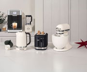 Küchenmaschine, Wasserkocher, Toaster und Kaffeevollautomat in einer modernen Küche, seitliche Perspektive