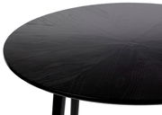 Runder schwarzer Esstisch FABIO aus Holz, Nahaufnahme der Tischplatte aus schräger Perspektive.