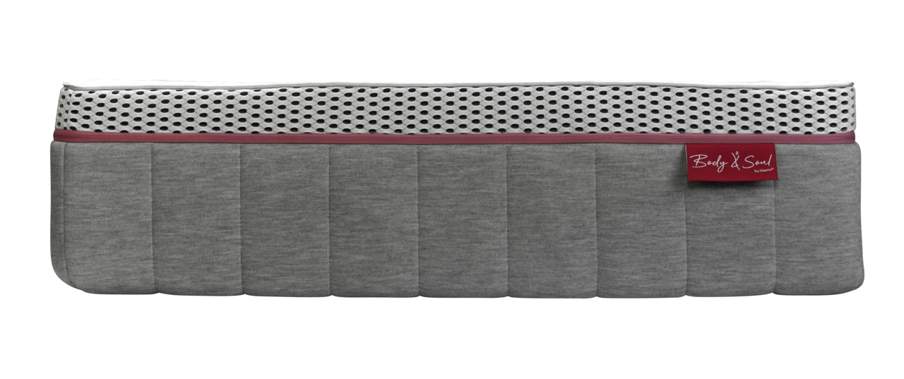 Seitenansicht einer Matratze 90x200 MEDIUM mit grauem Stoffbezug und weißem, atmungsaktivem Mesh-Einsatz.