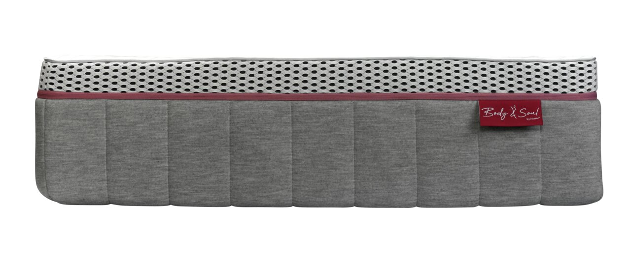 Seitenansicht einer Matratze 90x200 MEDIUM mit grauem Stoffbezug und weißem, atmungsaktivem Mesh-Einsatz.