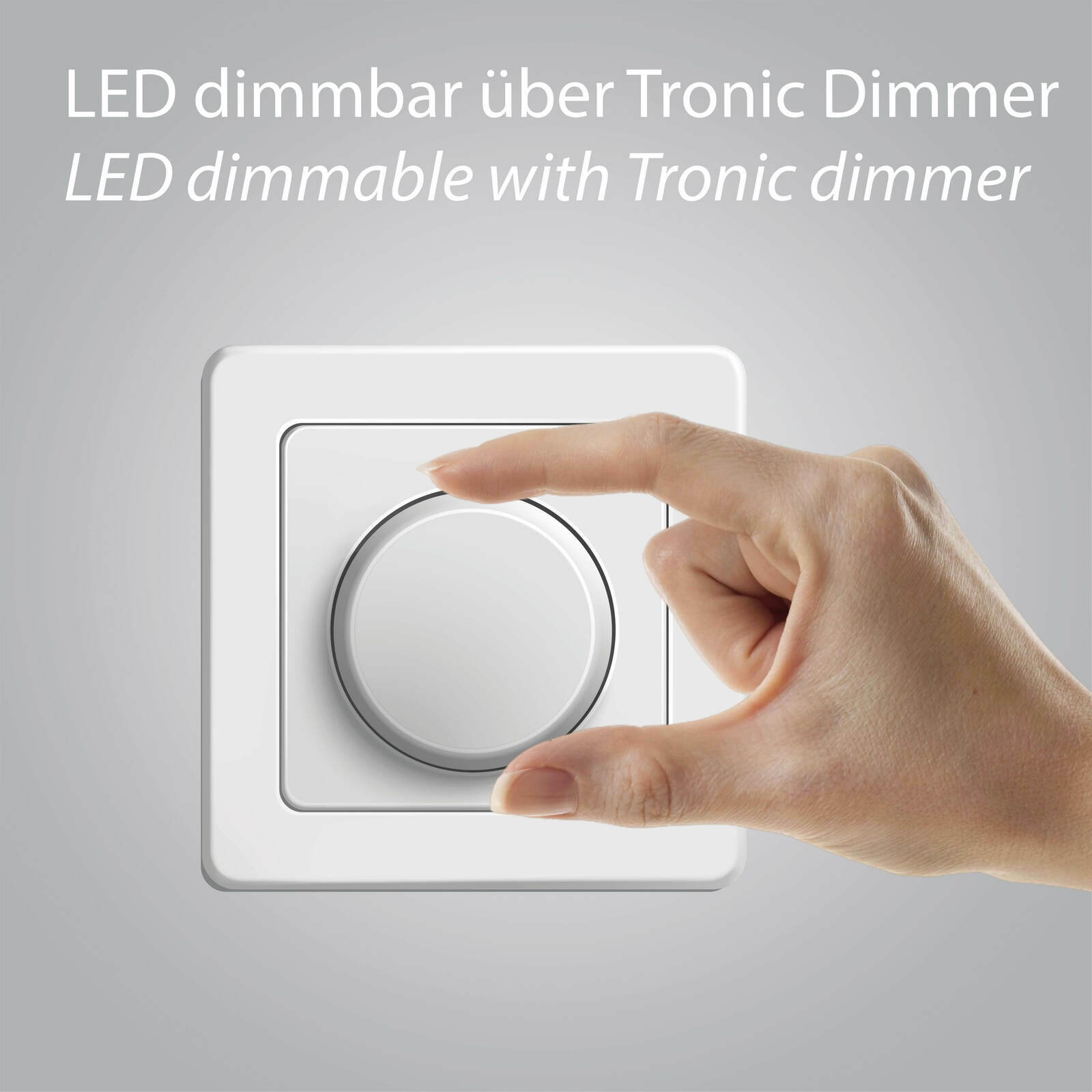 Nahaufnahme eines weißen Tronic-Dimmers, der von einer Hand bedient wird, mit der Aufschrift 'LED dimmbar über Tronic Dimmer'.