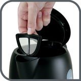 Nahaufnahme eines Wasserkochers Snow mit geöffneter Klappe, bei dem ein herausnehmbarer Filter von einer Hand gehalten wird.