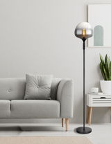 Moderne Stehleuchte mit rauchgrauem Glas in einem stilvollen Wohnzimmer, seitliche Perspektive.