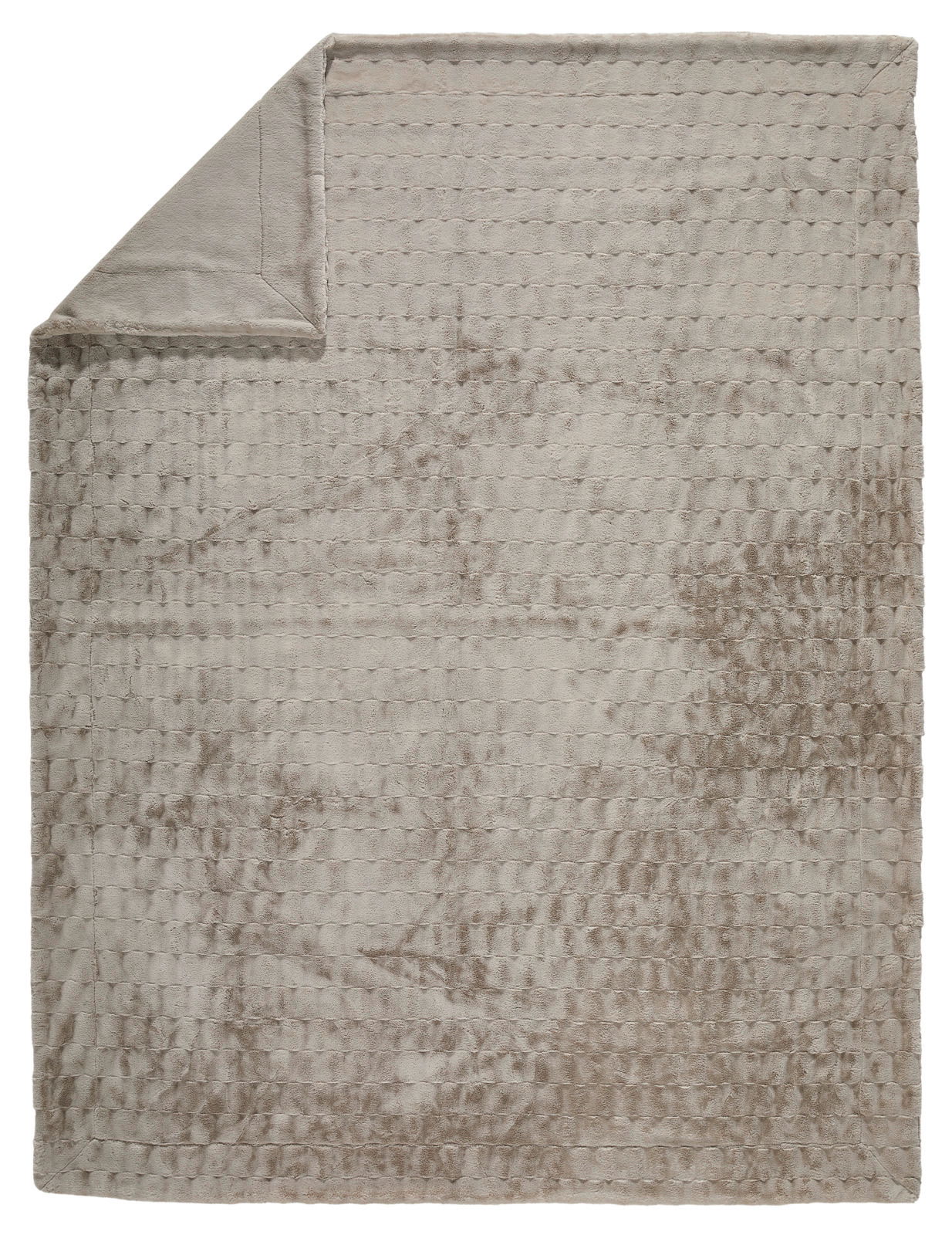 Beige Felldecke mit strukturierter Oberfläche, von oben fotografiert