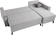 Graues Schlafsofa in L-Form, ausgeklappt als Bett, mit einem Kissen, Perspektive von oben.