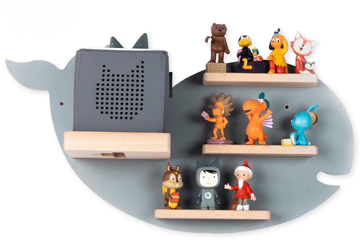 Graues, wal-/fischförmiges Wandregal aus Holz mit drei kleinen Ablageleisten und einer größeren Leiste, darauf bunte Spielfiguren und ein grauer Kinderlautsprecher mit Katzenmotiv Frontansicht.