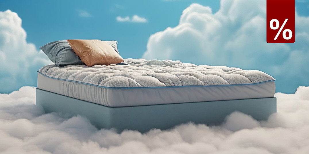 Eine Matratze mit Kissen schwebend auf einer Wolke im Himmel.