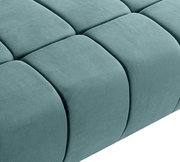 Nahaufnahme eines grünen Schlafsofas mit gestepptem Stoffbezug, seitliche Perspektive