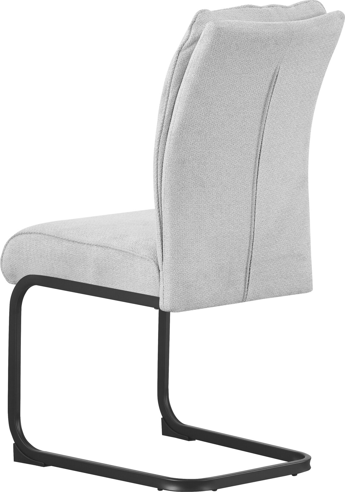 Beiger, gepolsterter Freischwinger-Stuhl mit schwarzem Metallgestell, seitliche Ansicht (leicht von hinten) vor weißem Hintergrund