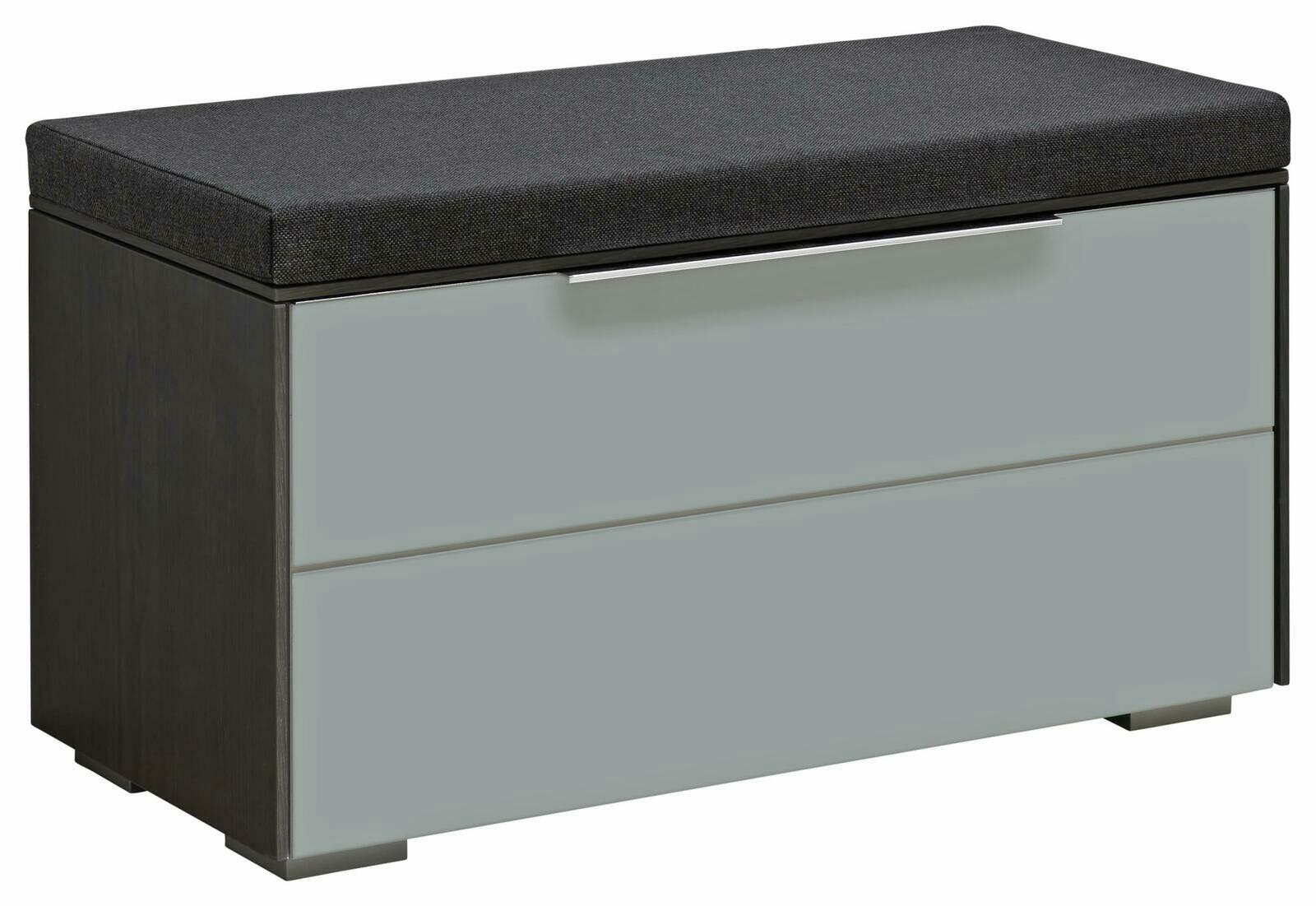 Bank aus der Serie LUXOR mit grauem Korpus und schwarzem Sitzpolster, seitliche Perspektive