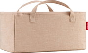 Beige opbergbox van stof met twee handvatten en een rood reisenthel-label, vooraanzicht licht van bovenaf tegen een witte achtergrond.